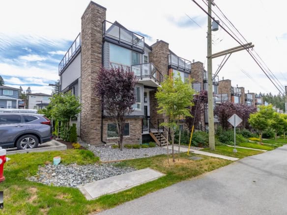 Contemporary multi-family residential buildings with modern architecture and landscaped surroundings in a suburban neighbourhood, showcasing Orca Realty Inc.'s property offerings in BC.