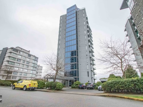 Modern high-rise condo building showcasing contemporary architecture in a Vancouver neighbourhood, featuring glass facades, balconies, and landscaped surroundings.