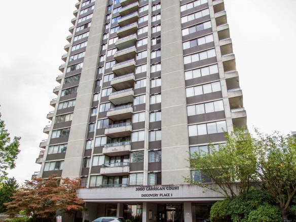 Modern high-rise condominium building at 3980 Carrigan Court, Discovery Place I, with glass balconies and 24-hour security, ideal for Vancouver area living.