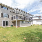 Spacious multi-level home with a large backyard and a covered deck, ideal for outdoor living and entertaining, located in a desirable neighbourhood in Canada.
