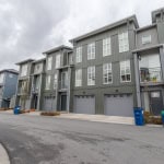 Modern multi-story townhomes with attached garages in a new residential community in Canada for sale or rent.