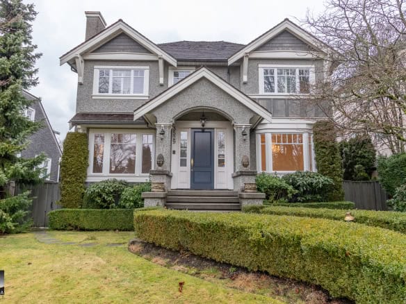 Bright two-storey family home with landscaped front yard and well-maintained garden in a established neighbourhood in Vancouver.