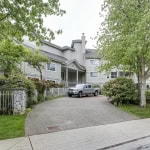 Lush greenery surrounds Orca Realty Inc. residential property with a gravel driveway and parked truck, showcasing a peaceful neighbourhood in Canada.