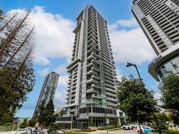 Modern high-rise condo building in Vancouver skyline cityscape, showcasing luxury apartments, spacious balconies, and contemporary architecture near urban amenities.