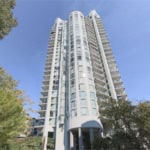 Modern high-rise condo building in Vancouver, BC, showcasing luxury apartments with panoramic city views by Orca Realty Inc.