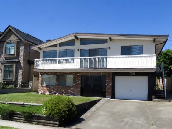 Spacious two-storey home with a balcony and attached garage located in a desirable neighborhood, perfect for families and investors seeking Vancouver Island real estate opportunities.