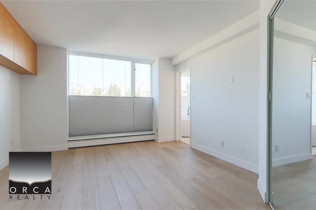 Bright and airy Vancouver condo interior with large windows, modern design, and natural light, ideal for comfortable urban living in a prime location with Orca Realty.