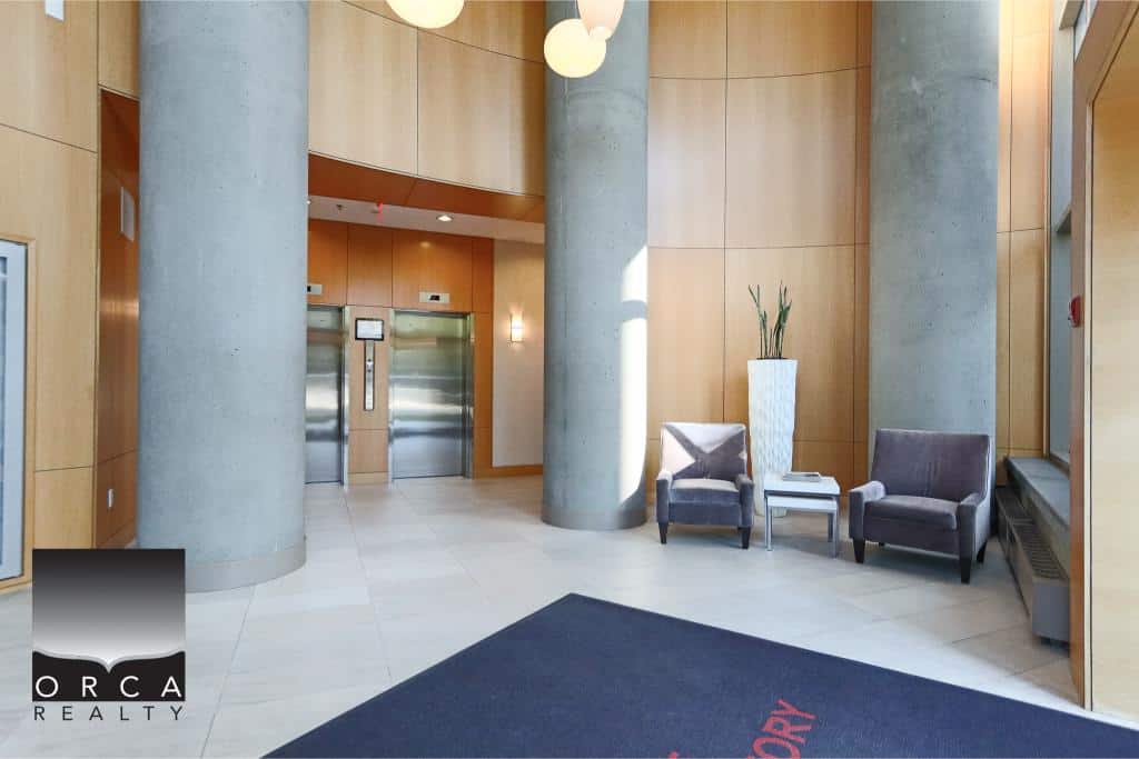 Modern lobby with elevator access, contemporary seating area, and attractive interior design at Orca Realty Inc.