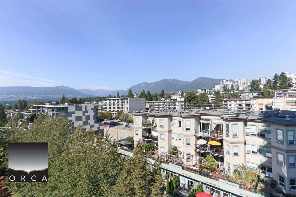 Modern Vancouver residential apartment buildings with mountain views in the background, showcasing prime real estate opportunities in BC.