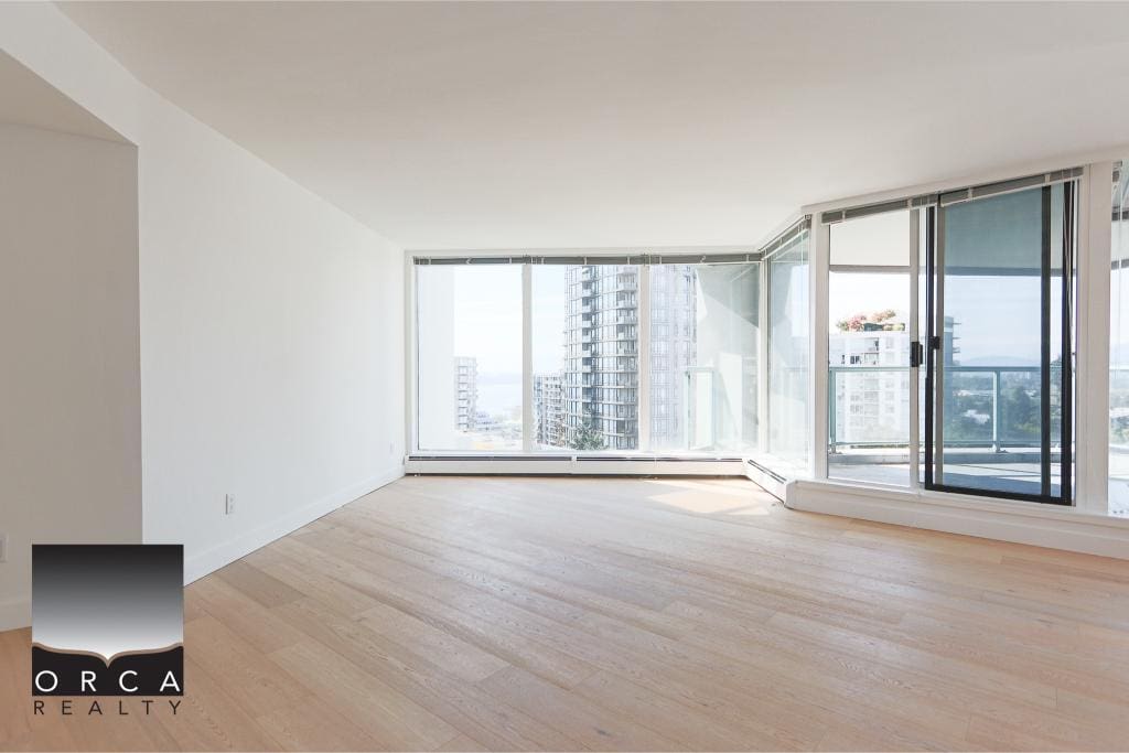 Bright modern condo with large floor-to-ceiling windows, offering spectacular city views and seamless indoor-outdoor living, ideal for real estate investment or a luxury lifestyle.