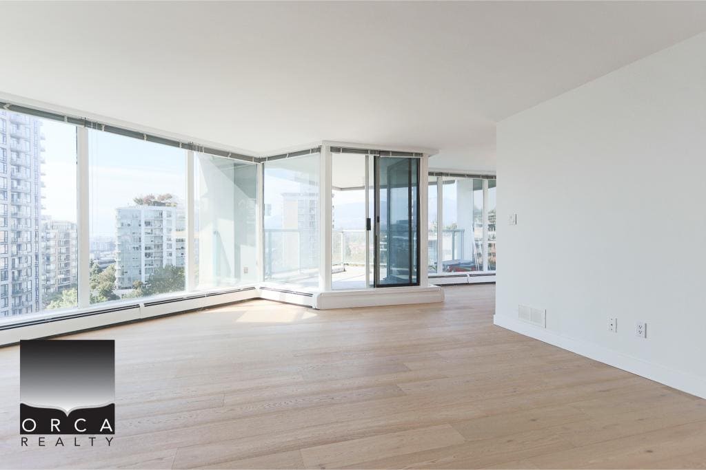 Bright spacious modern condo with floor-to-ceiling windows, overlooking city views, featuring clean finishes and natural light, ideal for downtown Vancouver living.