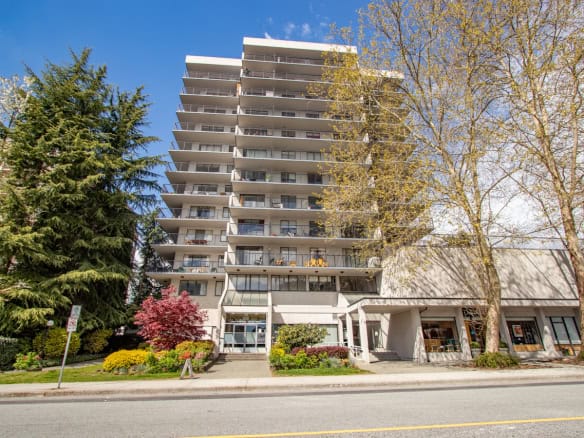 Modern downtown high-rise residential building with balconies and lush landscaping, available for real estate listings in Vancouver, BC.