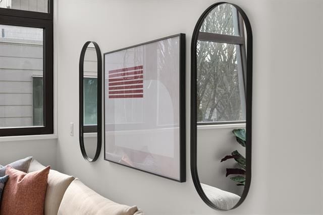 Modern minimalist interior decor with stylish oval mirrors and framed artwork in a contemporary living room, showcasing elegant home design and interior styling.