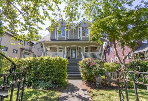 Charming featured home with lush gardens and front porch, showcasing Orca Realty Inc.’s expertise in Vancouver Island real estate. Perfectly situated for buyers seeking a beautiful, well-maintained property.