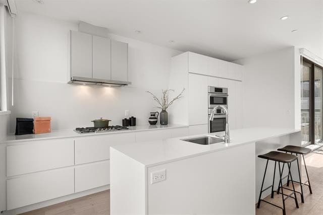 Modern minimalist white kitchen with sleek cabinetry and stainless steel appliances, ideal for Vancouver real estate listings and premium property marketing.