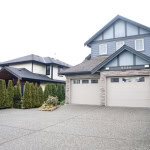 Modern suburban house with a spacious driveway and a double garage, located in a family-friendly neighbourhood in Vancouver, BC.