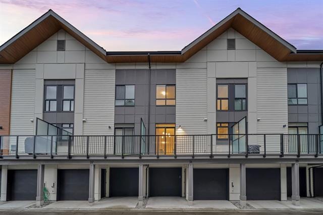 Modern multi-unit residential building with contemporary design, large windows, and balconies, ideal for urban living in Vancouver's real estate market.