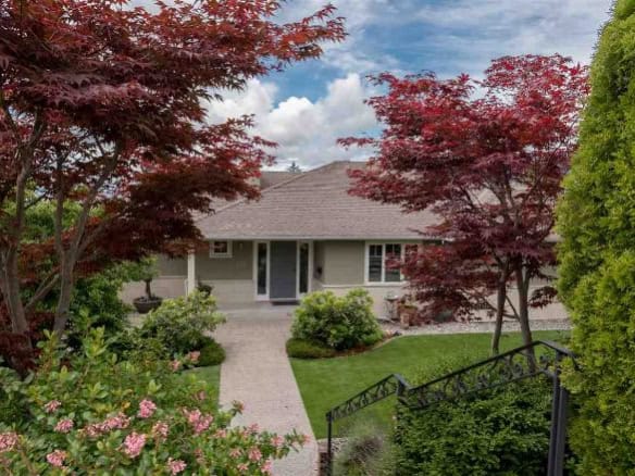 Lush garden with vibrant red and green foliage surrounding a modern suburban house in BC. Perfect for Canadian homeowners seeking a peaceful outdoor space.