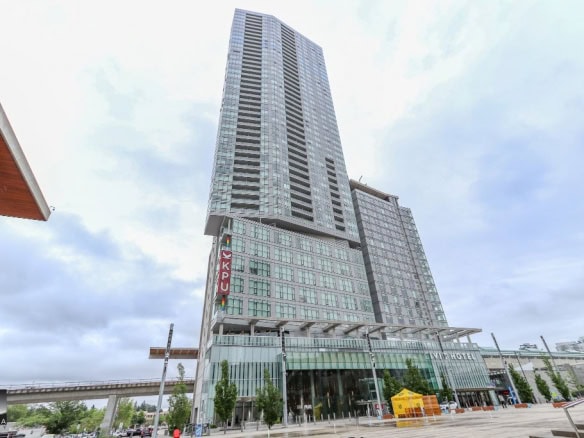 Luxurious modern high-rise building in downtown Vancouver, BC, featuring upscale living spaces and commercial areas, ideal for real estate investment in the Vancouver real estate market.
