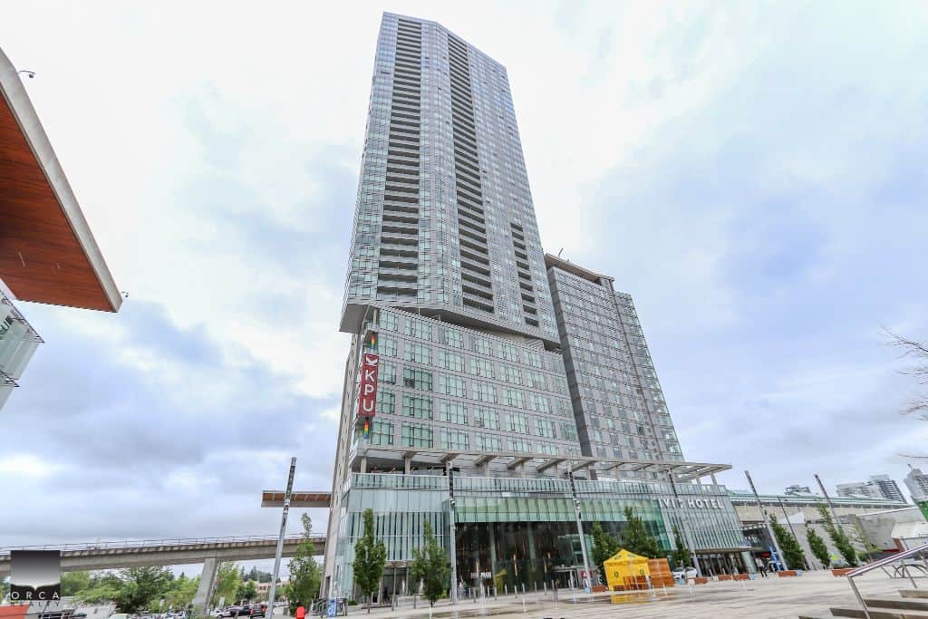 Luxurious modern high-rise building in downtown Vancouver, BC, featuring upscale living spaces and commercial areas, ideal for real estate investment in the Vancouver real estate market.