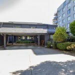 Modern residential property with lush landscaping and parking area, offered by Orca Realty Inc., showcasing prime real estate services in BC.