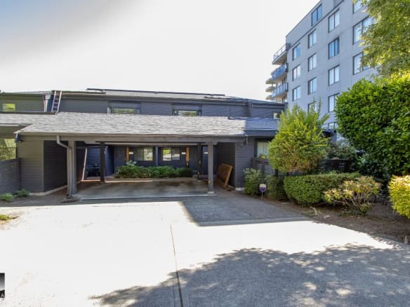 Modern residential property with lush landscaping and parking area, offered by Orca Realty Inc., showcasing prime real estate services in BC.