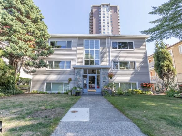 Modern multi-family residential building with landscaped front yard and high-rise apartment in downtown Vancouver, BC.
