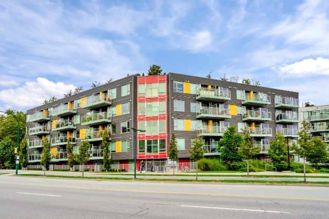 Modern multi-family residential apartment building with balconies and colorful exterior design in Vancouver, BC. Perfect for real estate investment and rental opportunities.