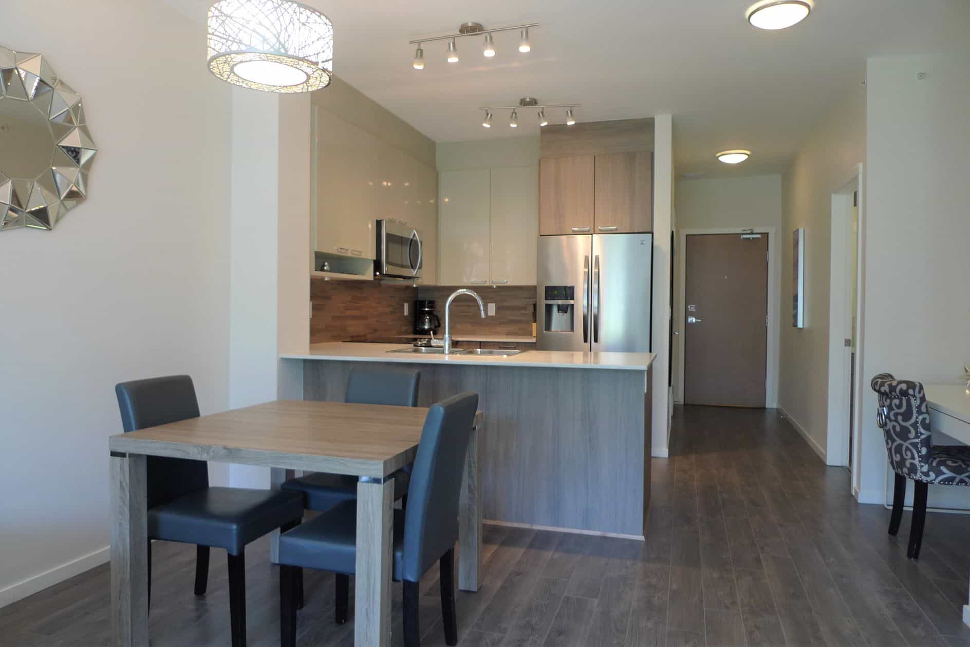 Bright modern kitchen and dining area at Orca Realty Inc. showcasing sleek appliances, minimalist design, and contemporary interior in a stylish residential property in Ontario.