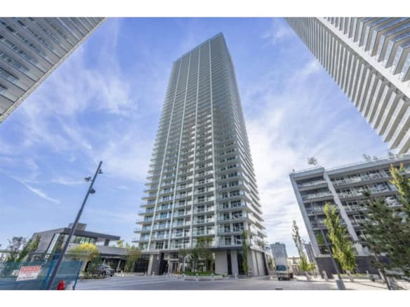 Luxurious modern high-rise condo building in downtown Vancouver, offering premier real estate opportunities and top-notch amenities.