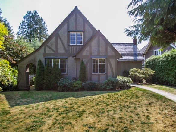 Charming Tudor-style home with manicured garden and lush landscaping in a quiet neighbourhood. Perfect for families seeking a cozy, historic house with modern updates, located near Vancouver Island.