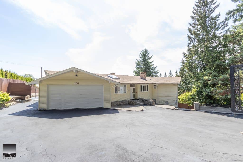 Spacious single-family home with attached garage, located in a serene neighbourhood with mature trees, perfect for families seeking a cozy, well-maintained property in BC.