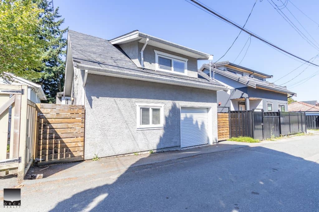 Modern residential home with garage and privacy fencing in an urban neighbourhood.