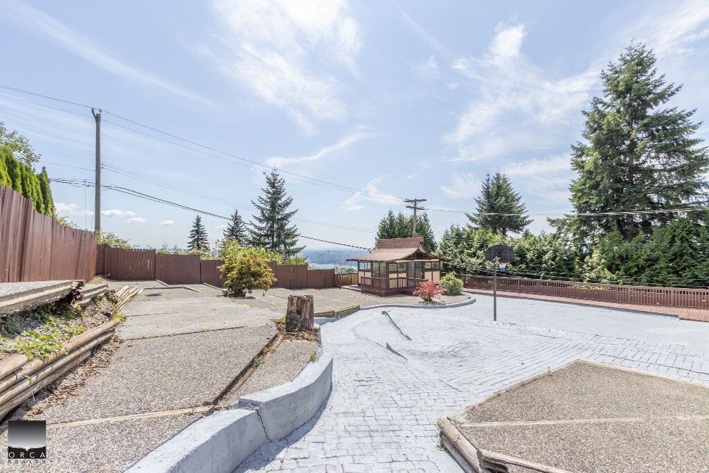 Spacious backyard with basketball court and gazebo, perfect for outdoor activities and entertaining, located in a quiet neighborhood with scenic views, ideal for families and outdoor enthusiasts.