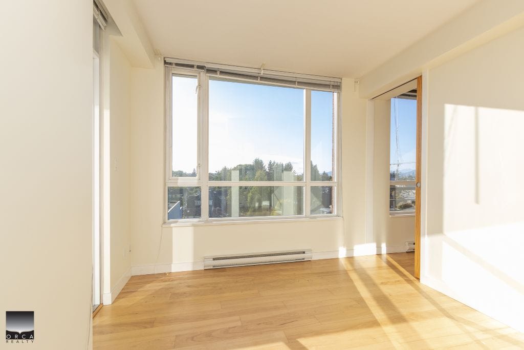 Bright, spacious living room with large windows and natural sunlight, ideal for Vancouver property buyers. Featuring hardwood floors, modern interior, and scenic views, perfect for condo or apartment rentals.