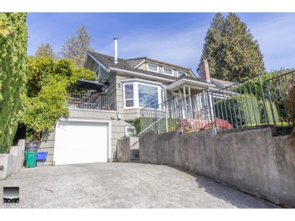 Spacious multi-level family home with stunning exterior and lush landscaping, located in a desirable neighbourhood in British Columbia, perfect for real estate investment and family living.