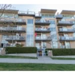 Modern multi-family apartment building with multiple balconies and large glass windows in a contemporary architectural style in Vancouver, BC.