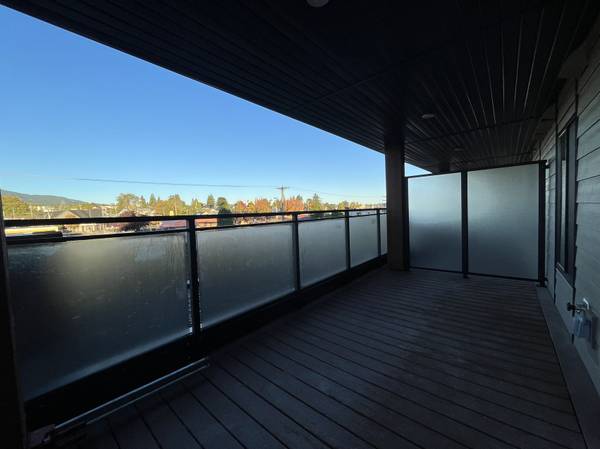 Balcony with glass railing overlooking scenic landscape, modern outdoor space, property listing, Orca Realty Inc.