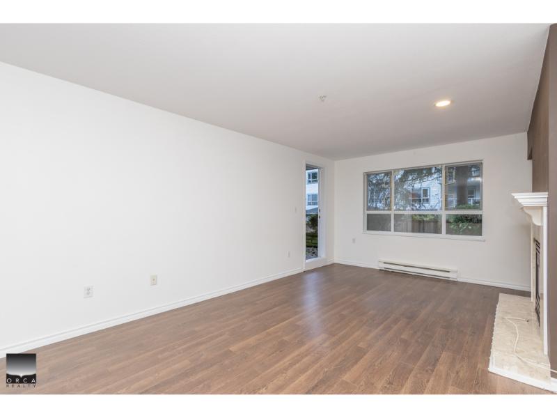 Spacious modern living room with hardwood floors, large windows, and natural light, ideal for Vancouver Island homebuyers seeking comfortable, stylish properties.