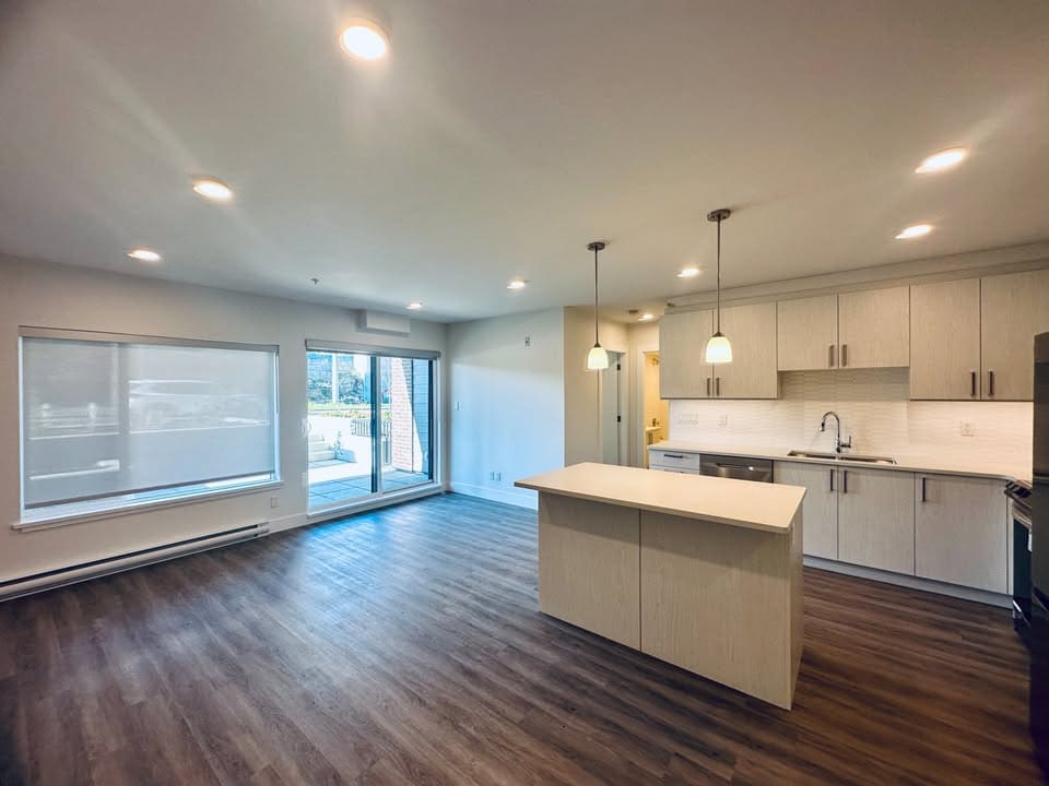 Bright and modern open-concept kitchen and living area in a Vancouver-area home listed by Orca Realty Inc. with ample natural light and stylish interior design.