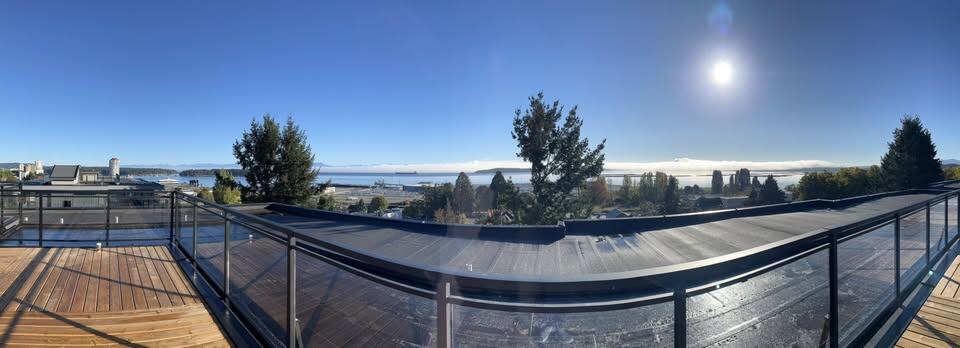 Dreamy waterfront view from a luxury property with modern design, showcasing the Vancouver skyline and natural surroundings, ideal for real estate investments in BC.