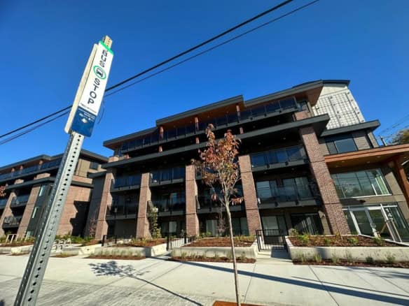 Modern multi-family residential building featuring contemporary architecture and balcony designs in a vibrant urban setting.