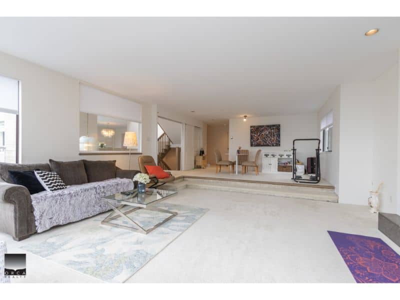 Spacious and modern living room with minimalist decor, neutral colour palette, large windows, and contemporary furniture, ideal for families and entertaining.