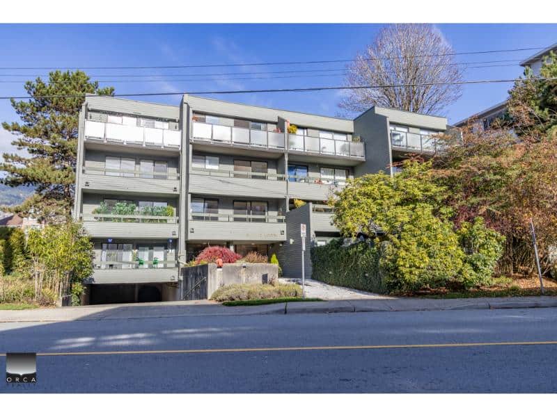 Spacious modern apartment building in Vancouver with multiple balconies, surrounded by lush greenery, ideal for real estate investment and property management in BC.