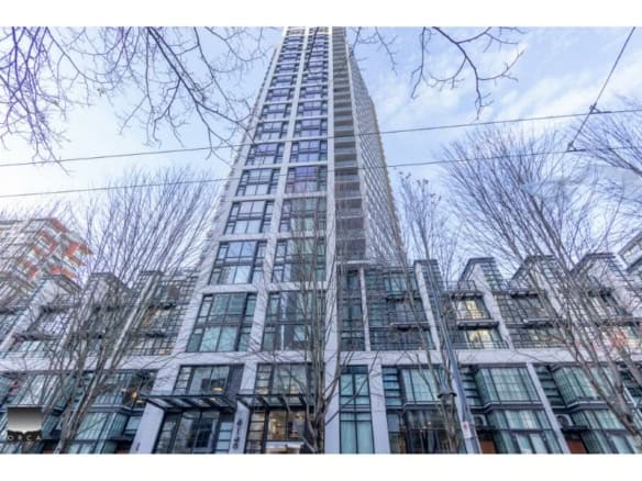Modern high-rise condo building in downtown Vancouver with glass facades and contemporary architecture.