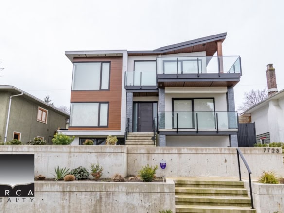 Modern multi-level house with contemporary architecture, large windows, and glass balconies, located in a desirable neighbourhood in Vancouver, BC, showcasing luxury real estate for sale or rent.