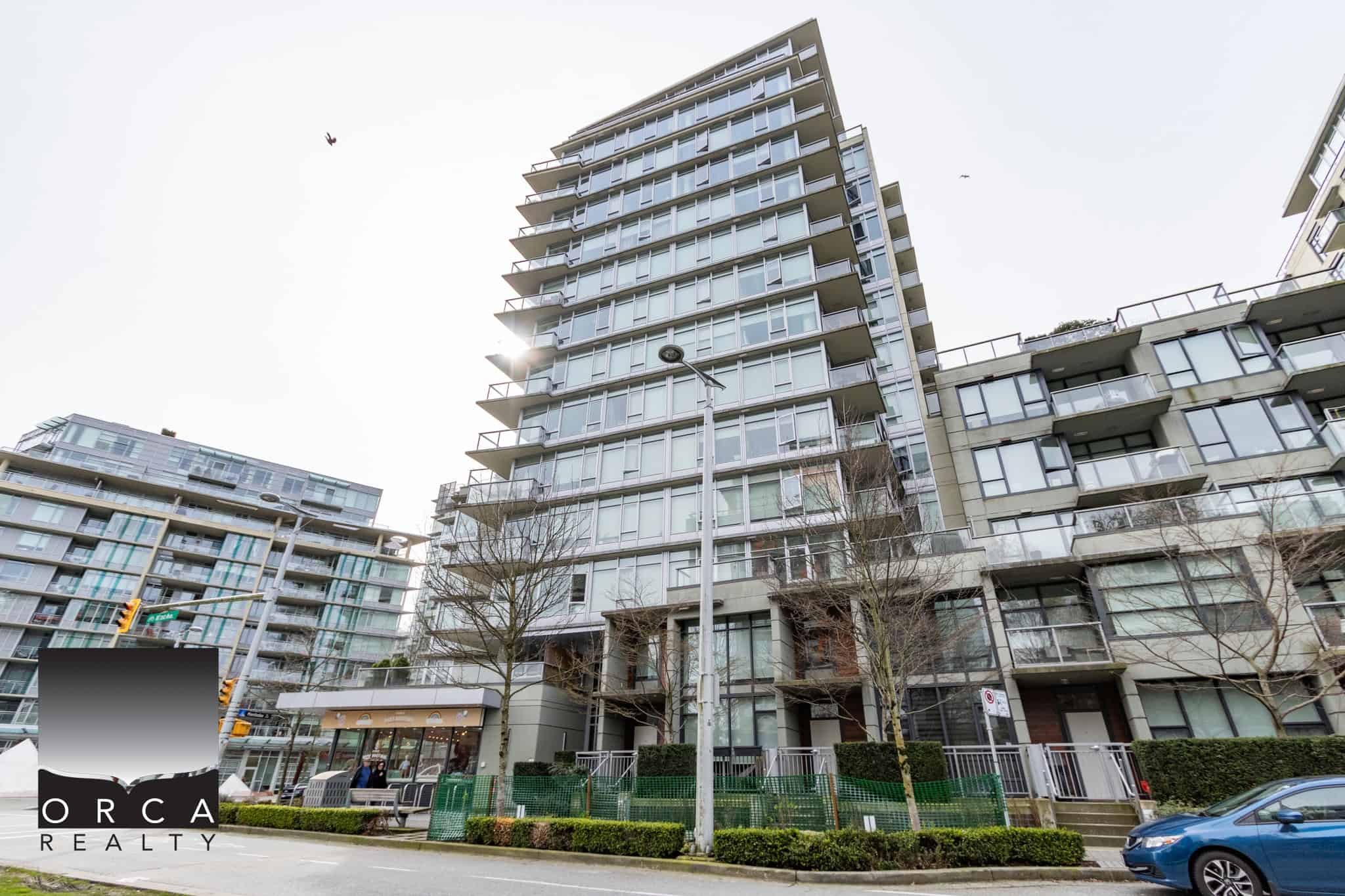 01 Modern waterfront condominium building in Vancouver, BC, showcasing contemporary architecture and large glass balconies, perfect for urban living.