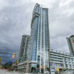 Luxurious modern high-rise condo building in Vancouver, BC with glass facade, urban amenities, and panoramic city views. Perfect for real estate investment and property sales in the Vancouver area.