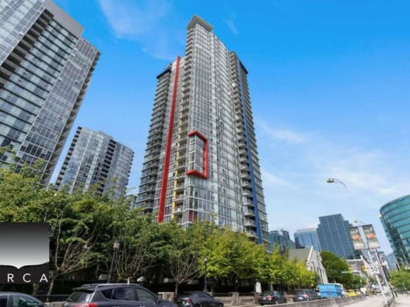 Modern high-rise condominium building in downtown Vancouver, BC, showcasing luxury real estate and urban living options offered by Orca Realty Inc.