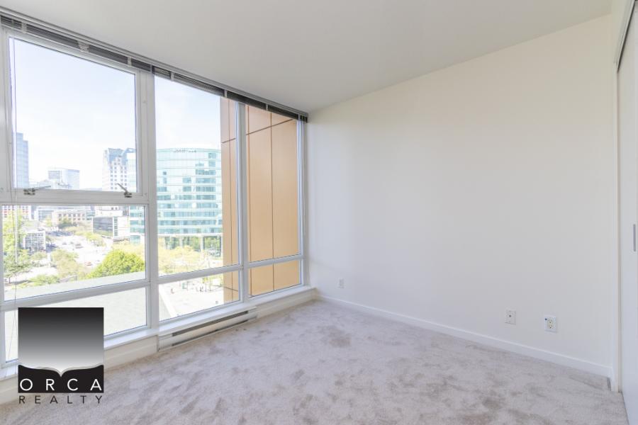 Bright modern Vancouver apartment with large floor-to-ceiling windows and scenic city views, perfect for urban living.